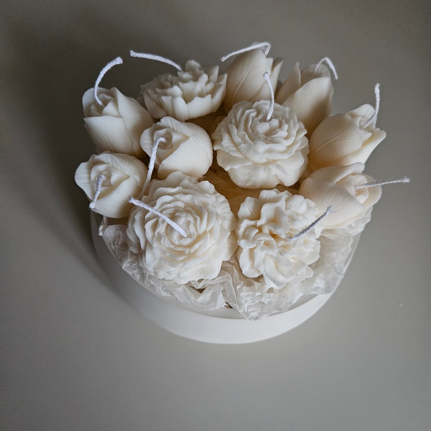 Candle flower bouquet in a plaster bowl peony, tulip and carnation