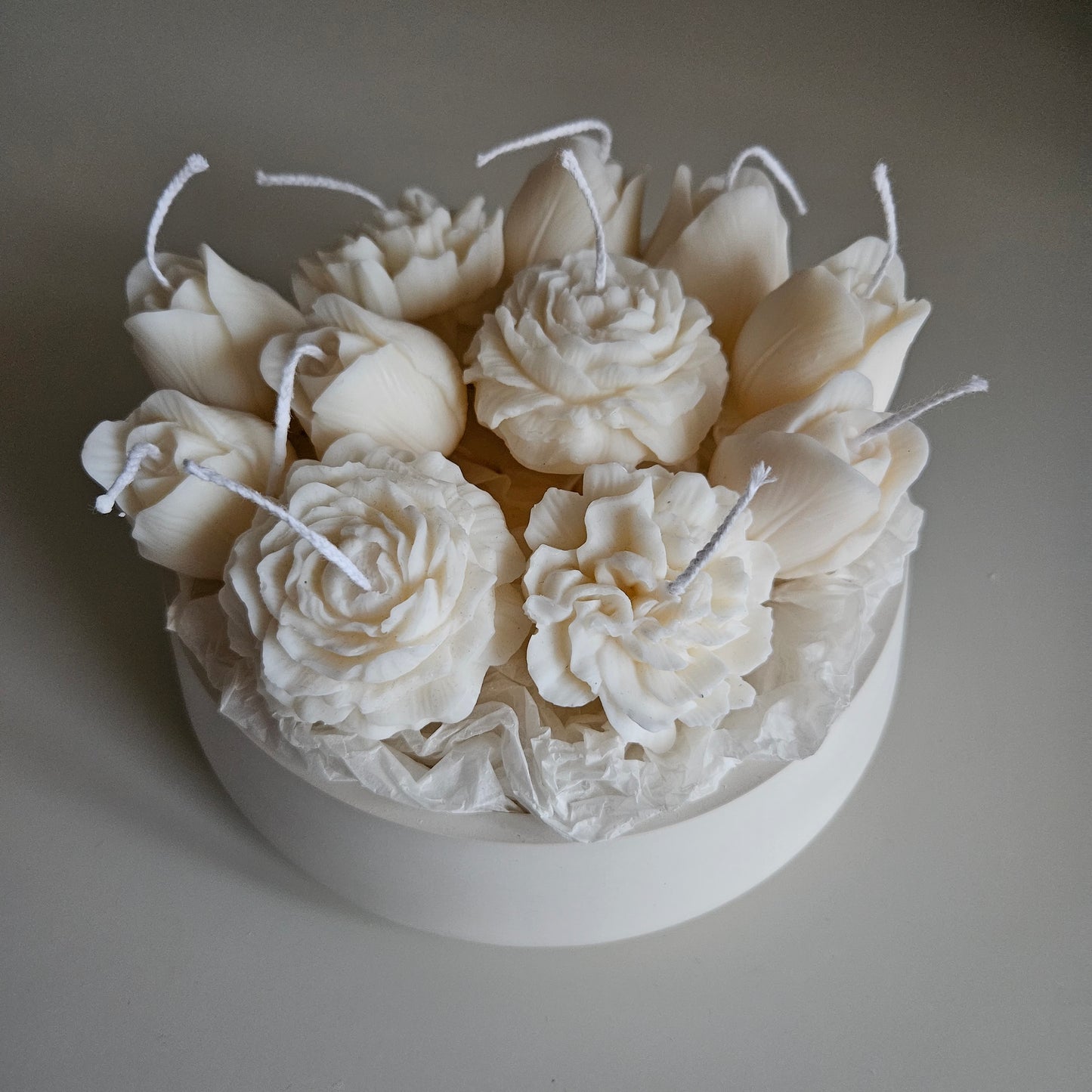Candle flower bouquet in a plaster bowl peony, tulip and carnation